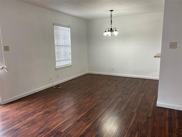 6201 Ranchester Dr Unit 48, Houston, TX 77036 - empty room with dark wood-style flooring and a chandelier