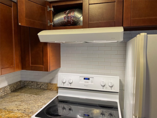 6201 Ranchester Dr Unit 48, Houston, TX 77036 - kitchen featuring white electric stove, decorative backsplash, range hood, and freestanding refrigerator