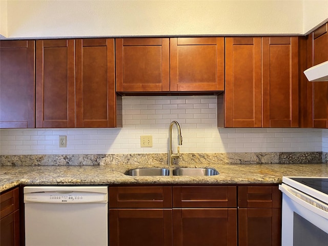 6201 Ranchester Dr Unit 48, Houston, TX 77036 - kitchen with white appliances, dark brown cabinets, decorative backsplash, and light stone countertops