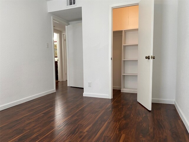 6201 Ranchester Dr Unit 48, Houston, TX 77036 - unfurnished bedroom featuring dark wood-style floors, a walk in closet, and a closet