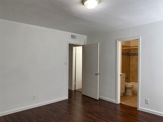 6201 Ranchester Dr Unit 48, Houston, TX 77036 - unfurnished bedroom featuring wood finished floors, a textured ceiling, and ensuite bathroom