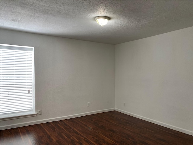 6201 Ranchester Dr Unit 48, Houston, TX 77036 - spare room featuring dark wood-style floors, healthy amount of natural light, and a textured ceiling