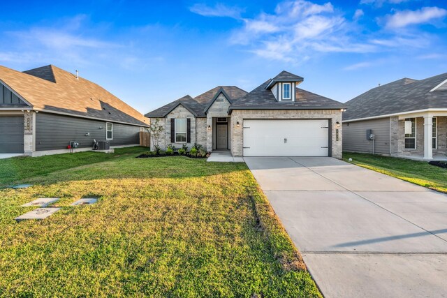 1418 Lake Ridge Dr, Brenham, TX 77833 - view of front of house featuring a garage, concrete driveway, a front lawn, and brick siding