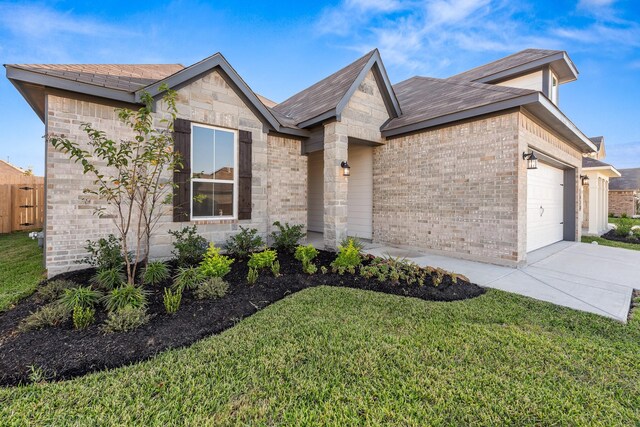 1418 Lake Ridge Dr, Brenham, TX 77833 - view of front of house with brick siding, an attached garage, a front lawn, driveway, and roof with shingles