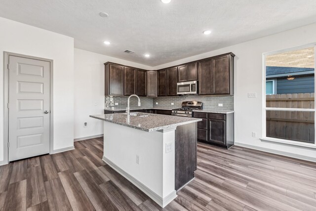 1418 Lake Ridge Dr, Brenham, TX 77833 - kitchen featuring stainless steel appliances, dark brown cabinets, dark wood finished floors, and recessed lighting