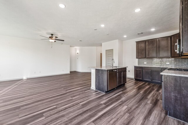 1418 Lake Ridge Dr, Brenham, TX 77833 - kitchen with ceiling fan, appliances with stainless steel finishes, an island with sink, open floor plan, and dark wood-type flooring