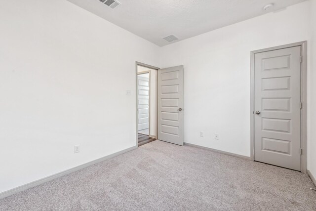 1418 Lake Ridge Dr, Brenham, TX 77833 - carpeted empty room with a smoke detector and baseboards