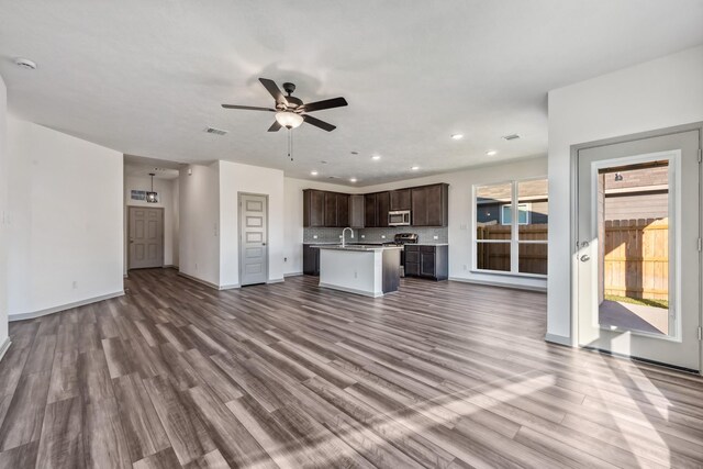 1418 Lake Ridge Dr, Brenham, TX 77833 - unfurnished living room featuring a ceiling fan, dark wood-type flooring, and recessed lighting