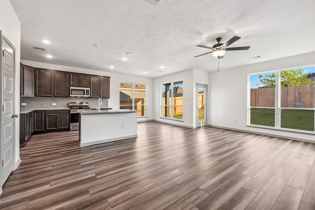 1418 Lake Ridge Dr, Brenham, TX 77833 - kitchen with appliances with stainless steel finishes, open floor plan, dark wood-style floors, ceiling fan, and dark brown cabinets