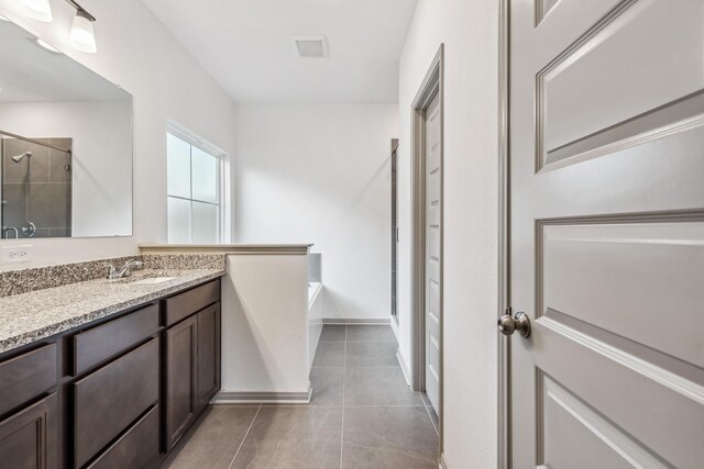 1418 Lake Ridge Dr, Brenham, TX 77833 - full bathroom with vanity, a garden tub, tile patterned floors, and a tile shower