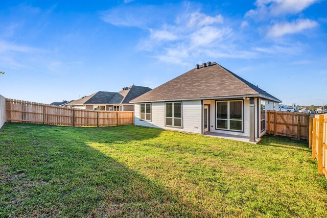 1418 Lake Ridge Dr, Brenham, TX 77833 - back of property featuring a fenced backyard and a shingled roof