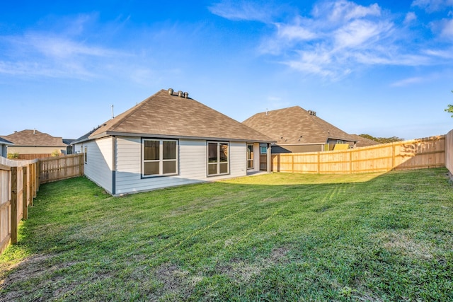 1418 Lake Ridge Dr, Brenham, TX 77833 - rear view of house with a fenced backyard and roof with shingles