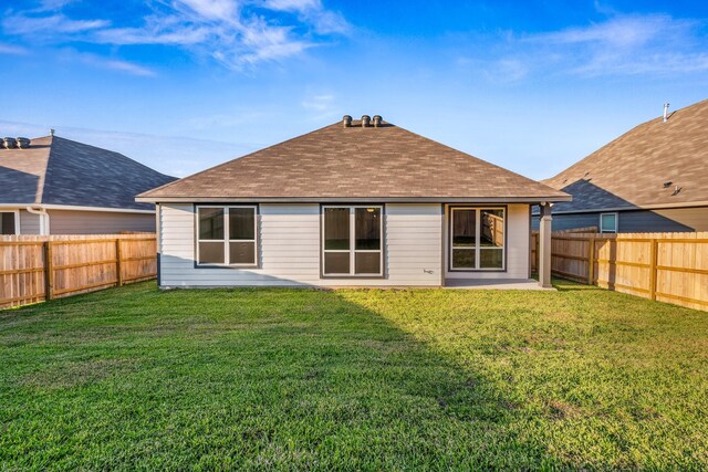 1418 Lake Ridge Dr, Brenham, TX 77833 - rear view of property featuring a fenced backyard, a shingled roof, and a patio area