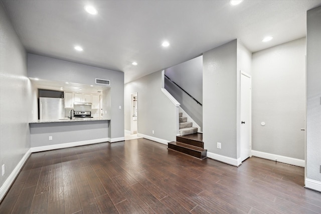 1920 Augusta Dr Unit 19, Houston, TX 77057 - unfurnished living room featuring dark wood-style floors, stairs, and recessed lighting