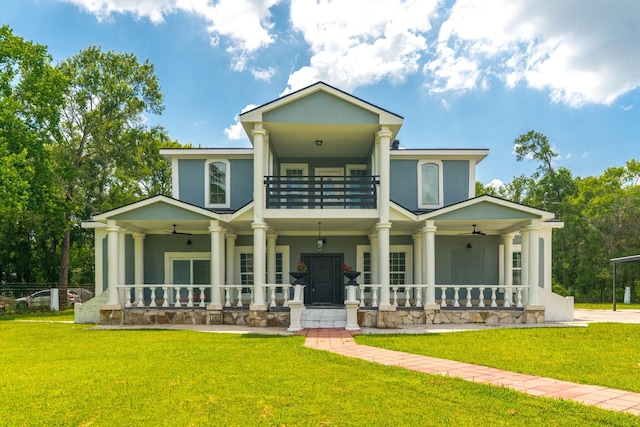 17128 Spindle Oaks Dr, Conroe, TX 77385 - view of front of house featuring a balcony, covered porch, ceiling fan, and a front lawn