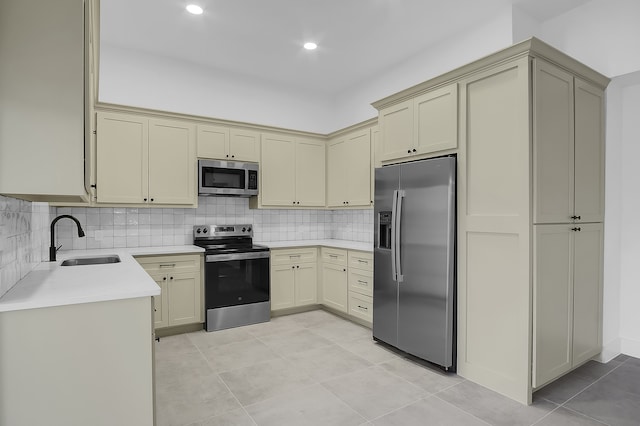 17128 Spindle Oaks Dr, Conroe, TX 77385 - kitchen featuring appliances with stainless steel finishes, cream cabinets, light countertops, and recessed lighting