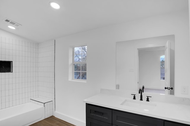 17128 Spindle Oaks Dr, Conroe, TX 77385 - full bathroom featuring vanity, wood finished floors, and bathing tub / shower combination