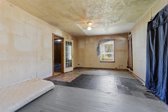 3110 Carter Blvd E, Tyler, TX 75702 - spare room featuring wooden walls, a ceiling fan, and wood finished floors