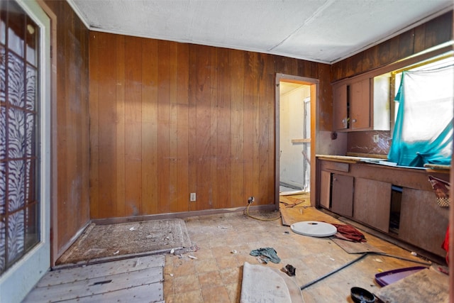 3110 Carter Blvd E, Tyler, TX 75702 - kitchen with wooden walls and a textured ceiling