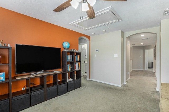 12414 Montebello Manor Ln, Tomball, TX 77377 - carpeted living area with attic access, a ceiling fan, and arched walkways