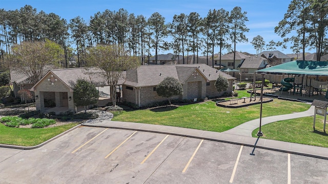 12414 Montebello Manor Ln, Tomball, TX 77377 - view of building exterior featuring uncovered parking and a residential view