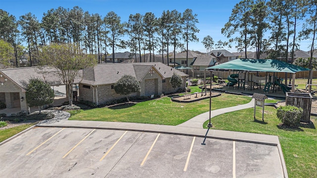 12414 Montebello Manor Ln, Tomball, TX 77377 - surrounding community with uncovered parking, a yard, and a residential view