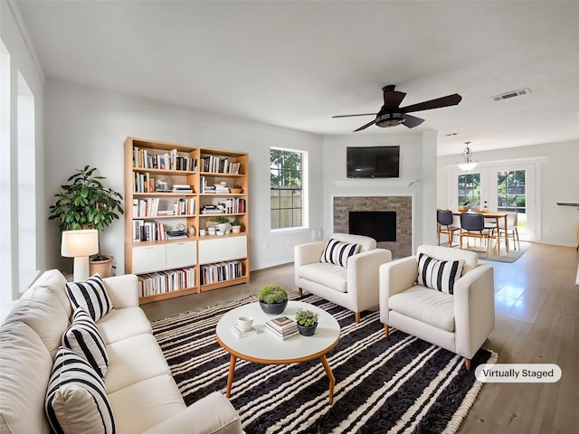7007 Madison Trl, Houston, TX 77084 - living room with ceiling fan, plenty of natural light, a fireplace, and wood finished floors