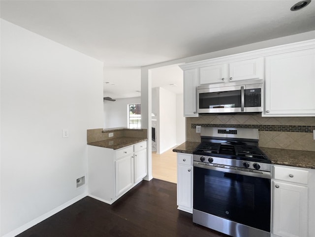 7007 Madison Trl, Houston, TX 77084 - kitchen with appliances with stainless steel finishes, dark wood-type flooring, and backsplash