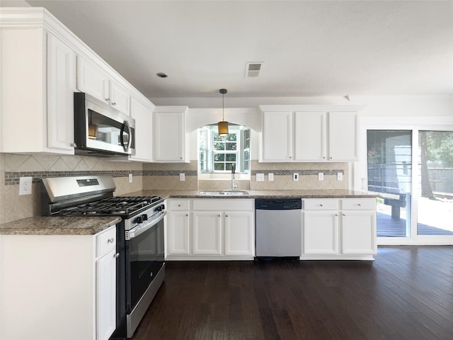 7007 Madison Trl, Houston, TX 77084 - kitchen with appliances with stainless steel finishes, dark wood-style floors, and white cabinetry