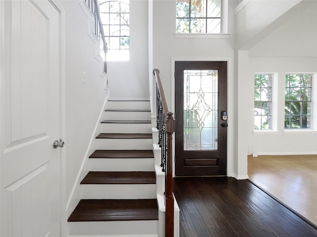 7007 Madison Trl, Houston, TX 77084 - entrance foyer with healthy amount of natural light, dark wood-style flooring, stairs, and a high ceiling