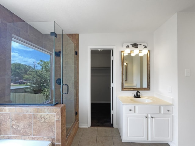 7007 Madison Trl, Houston, TX 77084 - bathroom featuring vanity, a stall shower, tile patterned flooring, a walk in closet, and a garden tub