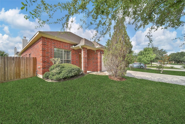 506 Glenwood Ridge Dr, Spring, TX 77386 - view of side of property with brick siding, concrete driveway, a chimney, and roof with shingles