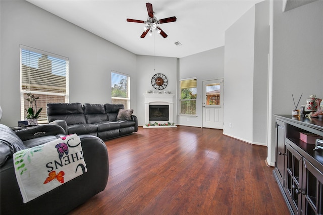 506 Glenwood Ridge Dr, Spring, TX 77386 - living room featuring ceiling fan, dark wood-style flooring, and a fireplace with raised hearth