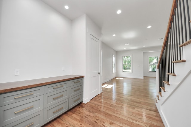 4541 Walker St, Houston, TX 77023 - hall featuring light wood-type flooring, recessed lighting, and stairway