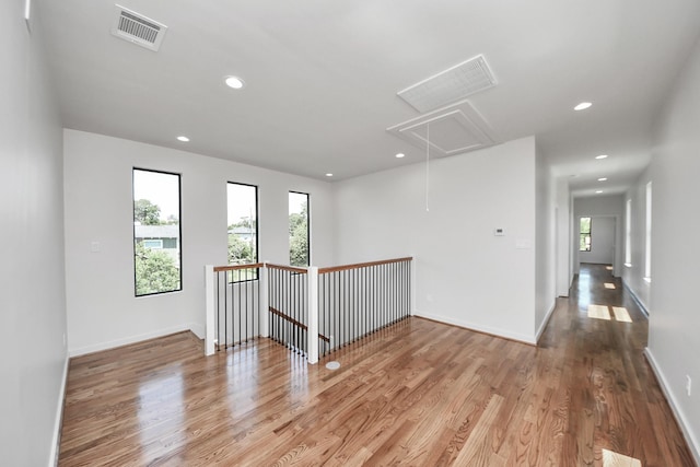 4541 Walker St, Houston, TX 77023 - spare room featuring attic access, wood finished floors, and recessed lighting