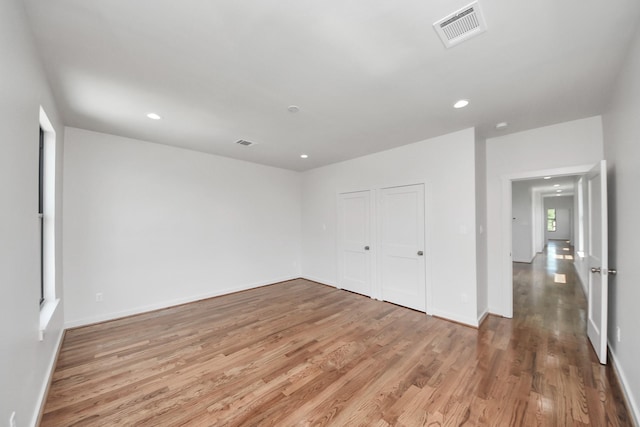 4541 Walker St, Houston, TX 77023 - unfurnished bedroom featuring light wood-type flooring, recessed lighting, and a closet