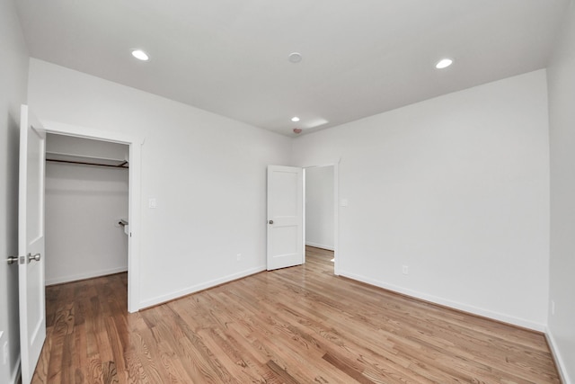 4541 Walker St, Houston, TX 77023 - unfurnished bedroom featuring light wood finished floors, a walk in closet, recessed lighting, and a closet