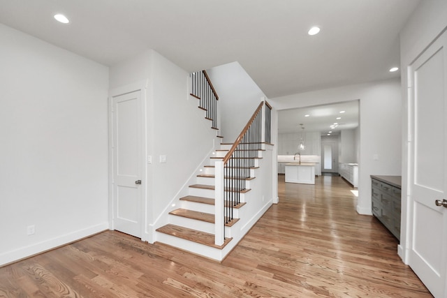 4541 Walker St, Houston, TX 77023 - stairs featuring wood finished floors and recessed lighting