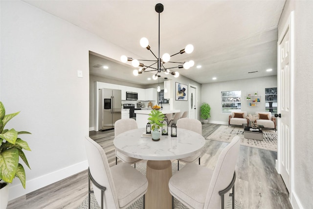 5817 Beechnut St, Houston, TX 77074 - dining room with light wood-style floors, a chandelier, and recessed lighting