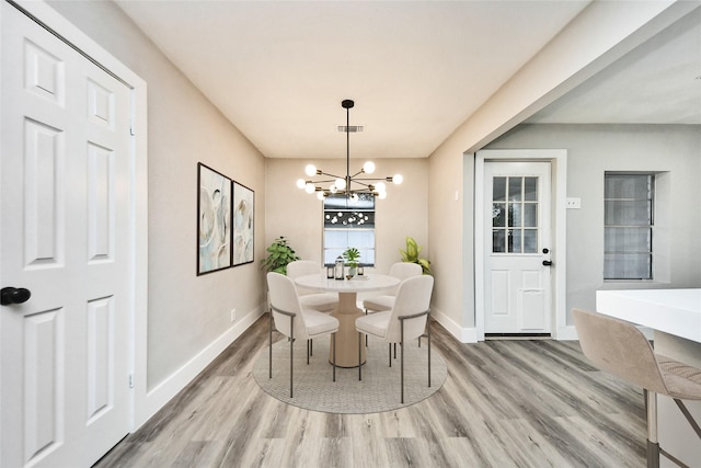 5817 Beechnut St, Houston, TX 77074 - dining area with wood finished floors and a chandelier