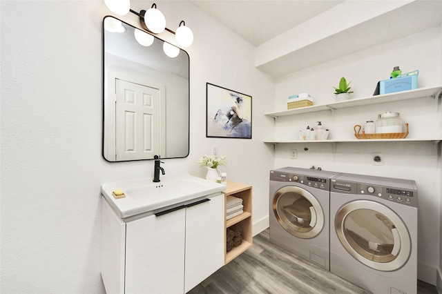 5817 Beechnut St, Houston, TX 77074 - laundry room featuring washing machine and dryer and wood finished floors