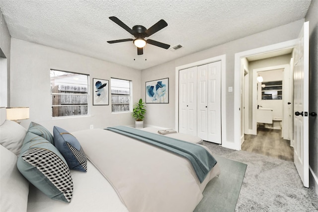 5817 Beechnut St, Houston, TX 77074 - carpeted bedroom featuring a closet, a textured ceiling, and ceiling fan