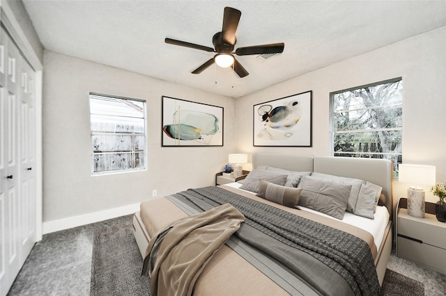 5817 Beechnut St, Houston, TX 77074 - carpeted bedroom featuring a closet, multiple windows, and a ceiling fan
