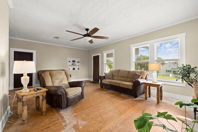 213 E Feagin St, Livingston, TX 77351 - living room with light wood-style flooring, a ceiling fan, crown molding, and a textured ceiling