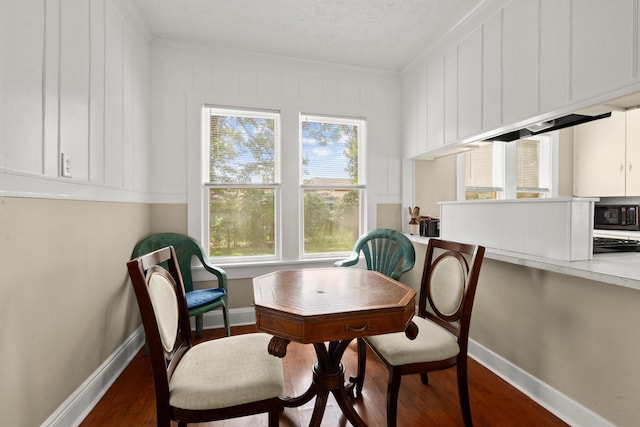 213 E Feagin St, Livingston, TX 77351 - dining area with wood finished floors, crown molding, an office area, and a textured ceiling