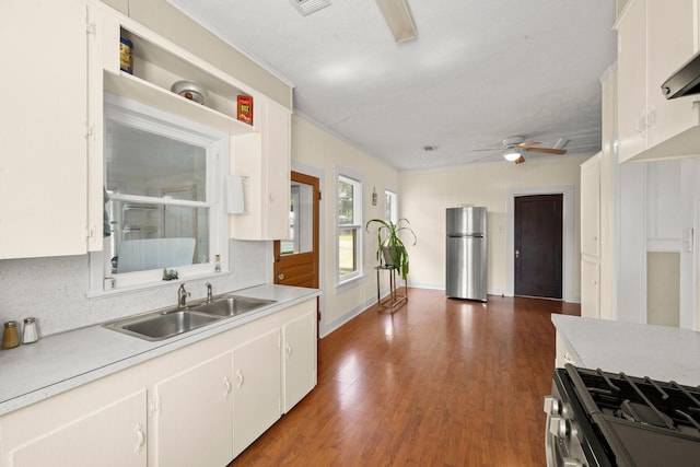 213 E Feagin St, Livingston, TX 77351 - kitchen with appliances with stainless steel finishes, ceiling fan, light countertops, crown molding, and dark wood finished floors