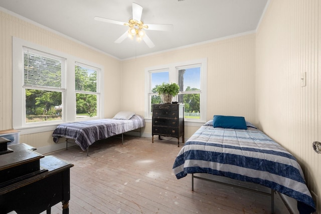 213 E Feagin St, Livingston, TX 77351 - bedroom featuring ornamental molding, light wood-style flooring, multiple windows, and ceiling fan