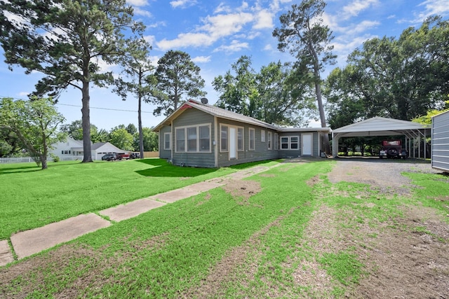 213 E Feagin St, Livingston, TX 77351 - view of front of house featuring a carport, dirt driveway, and a front yard