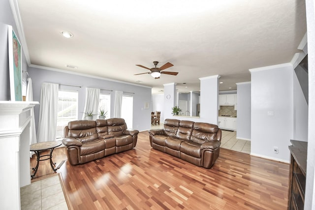 2613 Broussard Ct, Seabrook, TX 77586 - living room with a fireplace, light wood finished floors, ceiling fan, crown molding, and recessed lighting