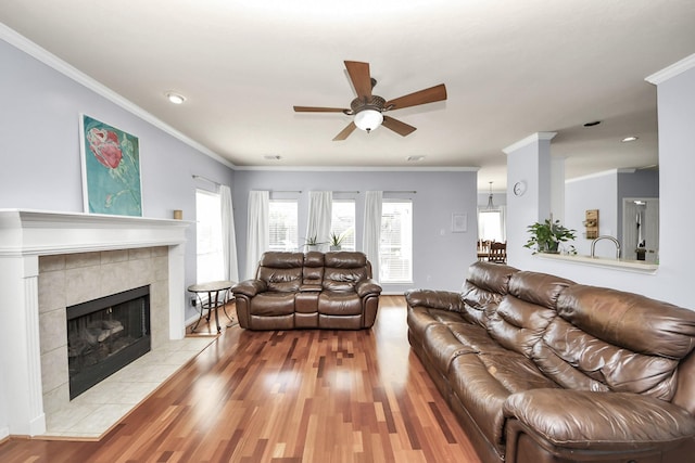 2613 Broussard Ct, Seabrook, TX 77586 - living room featuring ceiling fan, wood finished floors, crown molding, a tile fireplace, and recessed lighting